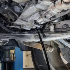 Wymiana oleju w skrzyni manualnej Honda CRV. Widać lejek wlewający nowy olej do skrzyni biegów.