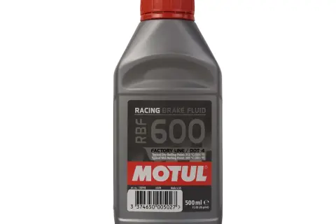 Szara butelka płynu hamulcowego Motul RBF 600 z czerwoną zakrętką.